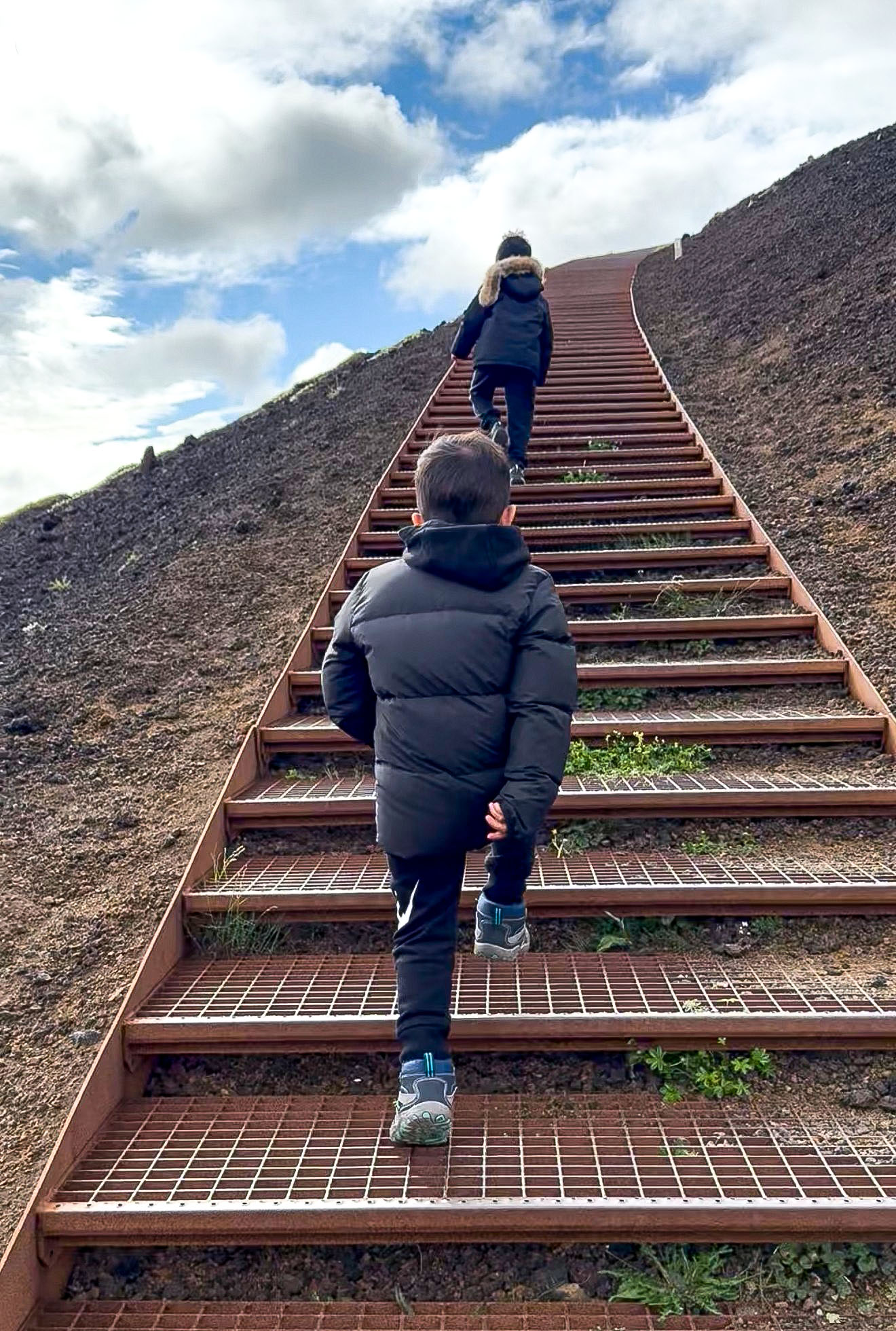 The kids climbing the stairs at Saxholl Crater, a dormant volcano.
